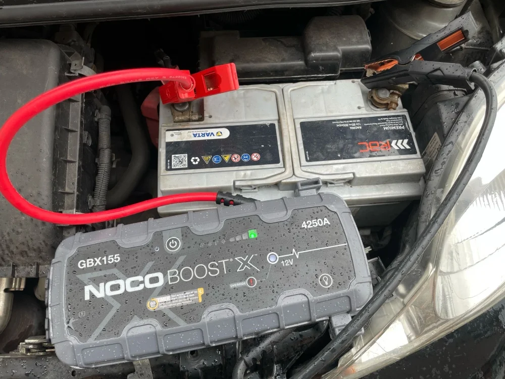 Professional jump pack connected to a flat car battery